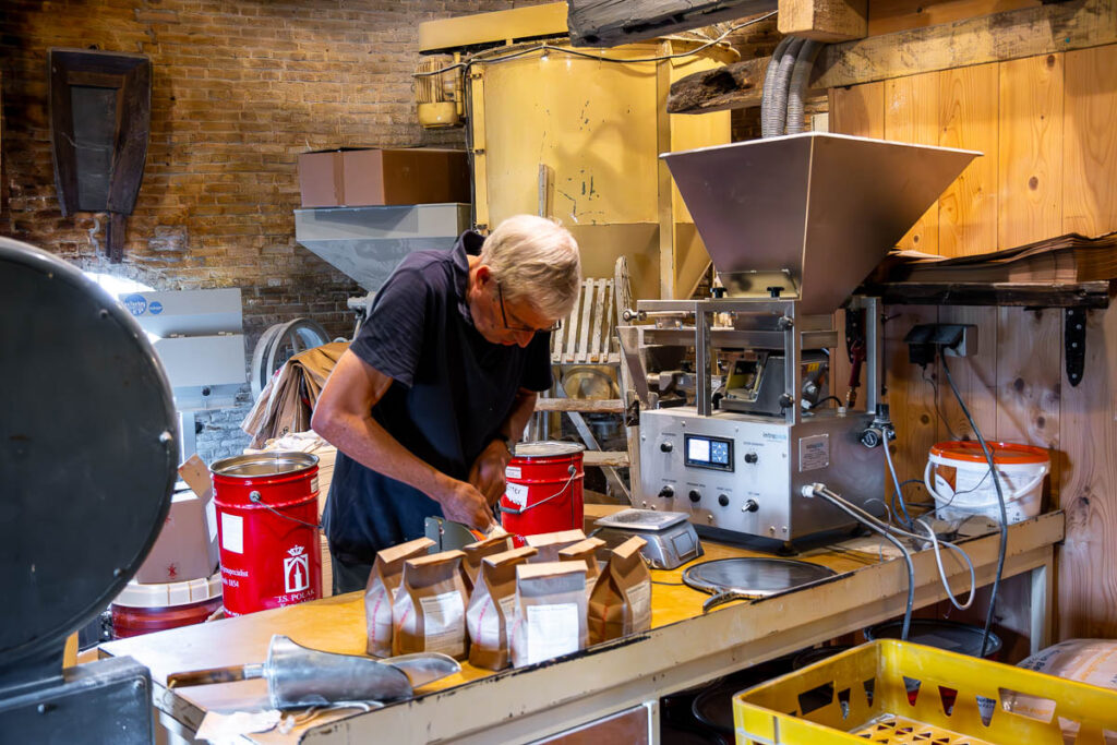 grinding flour at windmill De Windhond in Woerden